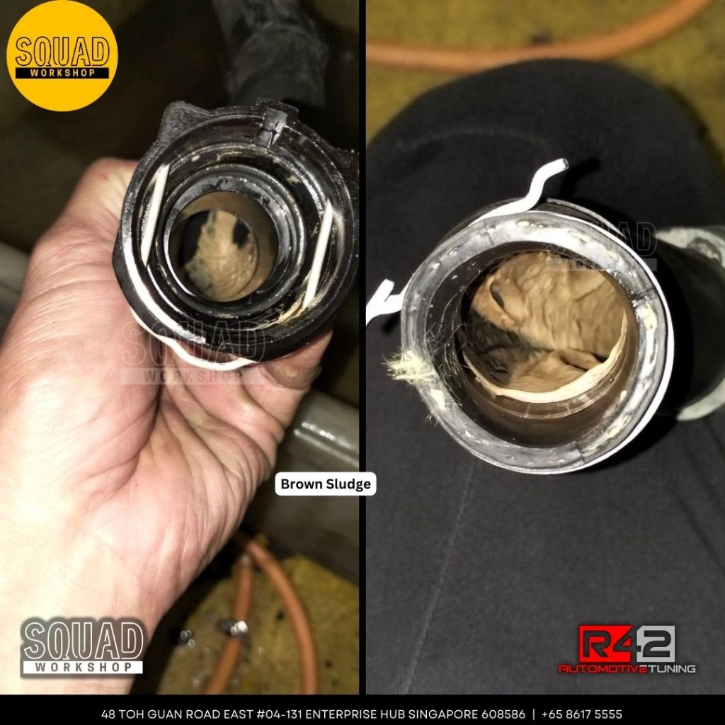 Volkswagen Passat coolant tank with brown oil contaminated sludge