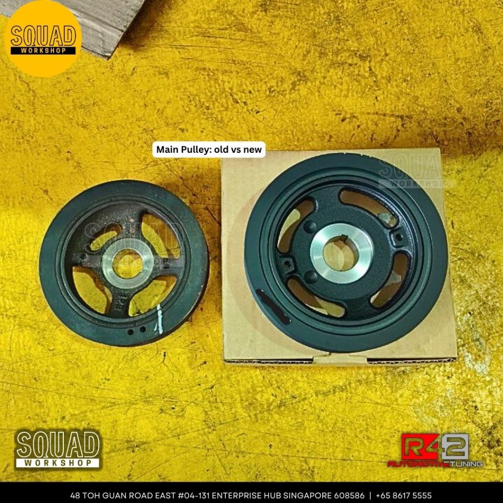 Nissan Note engine pulley inspection showing cracked rubber damper causing squeaky noise